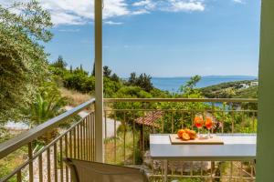 a balcony with a table and a view of the ocean at Amorosa Nest - Adults Only by Eutopia in Syvota