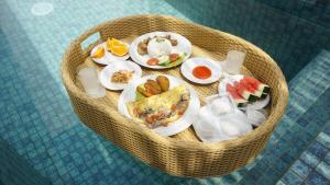 a basket full of food on a table at Ayodhya Villa Utari - North Wings in Yogyakarta