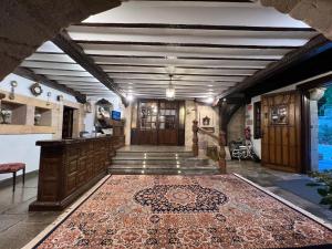 a hallway with a rug on the floor at Hotel Santillana in Santillana del Mar