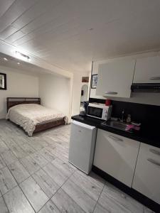 a room with a kitchen and a bed in it at Studio agréable et paisible in Aubagne