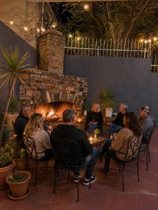 a group of people sitting in chairs in front of a fireplace at SapphireA@54 in Windhoek