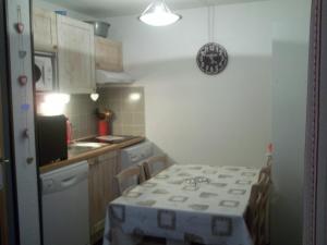 a small kitchen with a table and a sink at Les Gloriettes in Luz-Saint-Sauveur