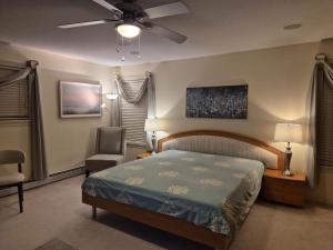 a bedroom with a bed and a ceiling fan at Meadowridge Haven in Maple Ridge