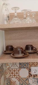 a couple of pots and pans on a shelf at Studio apartman Fortica in Otočac