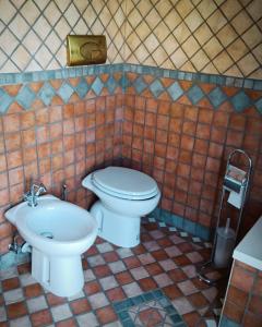 a bathroom with a toilet and a sink at Domus Liberty Luxury House in Sala Consilina +38 photos