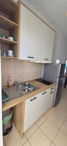 a kitchen with a sink and a refrigerator at Aggeliko Seaside in Gythio
