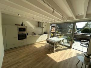 a kitchen and dining room with a table and a view at Chambre haute in Eupen