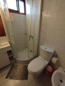 a bathroom with a shower and a toilet and a sink at casa Andylu in Punta Del Diablo +23 photos