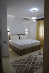 a bedroom with a large bed in a room at Villa Nano in Berat