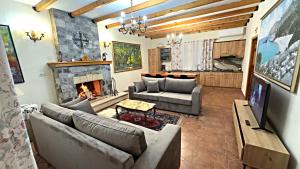 a living room with couches and a fireplace at Kulla e Andrrave in Ducaj