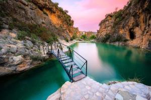 a staircase leading into a body of water at Casa el Pato Lolo in Bolbaite
