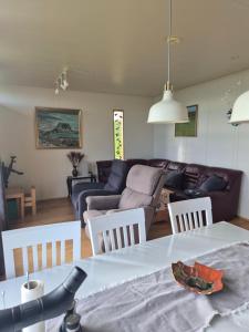a living room with a couch and a table and chairs at Miðjanes Reykhólahrepp in Reykhólar