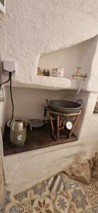a kitchen with a shelf with a tea pot and a sink at Veža na vlásku in Háj