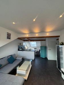 a living room with a couch and a table at Ferienwohnung Roller in Endingen