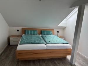 a bedroom with a large bed with blue pillows at Ferienwohnung Roller in Endingen +53 photos
