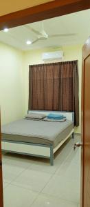 a bed in a room with a window at Impian Melaka Homestay in Malacca