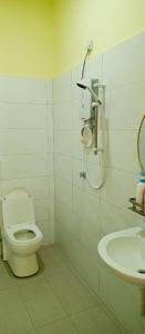 a bathroom with a toilet and a sink at Impian Melaka Homestay in Malacca
