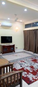 a living room with a flat screen tv and a couch at Impian Melaka Homestay in Malacca