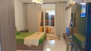a bedroom with a green bed in a room at Luxury Studio, pool, Private beach & close to Airport in Hurghada