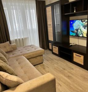 a living room with a couch and a flat screen tv at Mykolaichuka in Chernivtsi