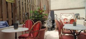 a row of tables and chairs in front of a store at PARIS AUTHENTIC HOUSE open space studio Métro 14 Hôpital Bicêtre, RER B Gentilly in Gentilly