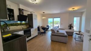 a kitchen and living room with a couch and a table at Villa Stanić in Omiš