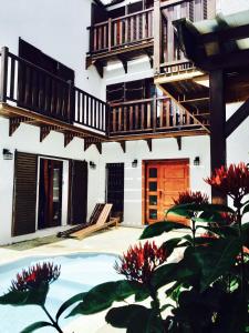 a house with a swimming pool and a balcony at Sannyasa Wellness and Spa in Trou aux Biches
