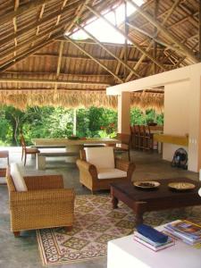 a living room with chairs and a table in a building at Casa Carey in Palomino