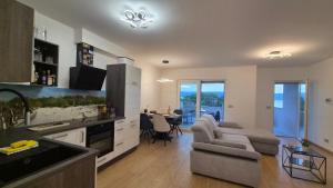 a kitchen and living room with a couch and a table at Villa Stanić in Omiš