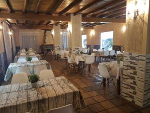a dining room with tables and chairs in a building at Complejo Godoy in Losar de la Vera