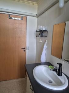 a bathroom with a sink and a mirror and a door at Miðjanes Reykhólahrepp in Reykhólar +80 photos