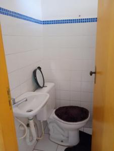 a bathroom with a toilet and a sink at Boêmia carioca in Rio de Janeiro +7 photos