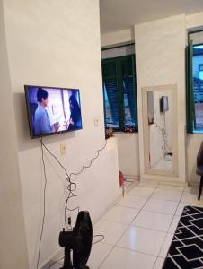 a living room with a flat screen tv on the wall at Boêmia carioca in Rio de Janeiro