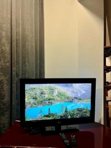 a flat screen tv sitting on top of a table at PARIS Luxury Center Apartment STRUGA in Struga