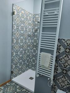 a bathroom with a shower with a tile wall at A casa di Anna in Cocconato +11 photos