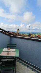 a table and chairs on a balcony with a view at A casa di Anna in Cocconato