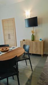 a dining room with a table and chairs and a television at A casa di Anna in Cocconato
