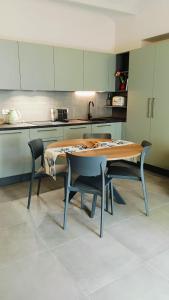 a kitchen with a table and two chairs and a table at A casa di Anna in Cocconato
