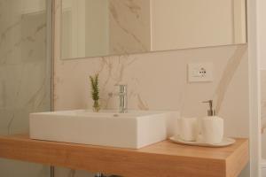 a bathroom with a white sink and a mirror at Nafura in Raffadali +60 photos