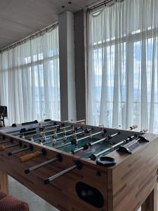 a large wooden billiard table with bats on it at Villa Enhalon in Struga