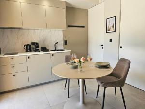a kitchen with a table with two chairs and a counter at Suite Sieste en Provence in Entrecasteaux