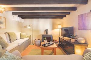 a living room with a couch and a stove at Casa de Suenos in Comares
