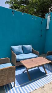 a couch and a coffee table on a patio at La Casita de Ceiba in Ceiba