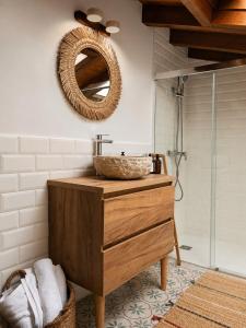 a bathroom with a sink and a mirror on the wall at Laguna de Valfría in Fresneda +41 photos