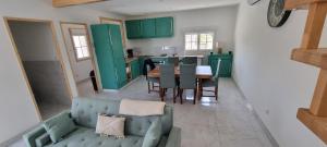 a living room with a blue couch and a table at La Grange in Champagne-de-Blanzac