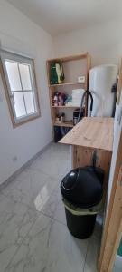 a room with a table and a trash can at La Grange in Champagne-de-Blanzac +9 photos