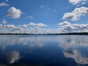 a large body of water with clouds in the sky at Ferienwohnung Wusterwitz in Wusterwitz