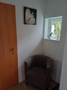 a room with a chair and a window at Ferienwohnung Wusterwitz in Wusterwitz