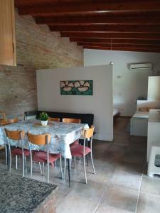 a dining room with a marble table and chairs at Casa Las Tardes, Roldan in San Lorenzo
