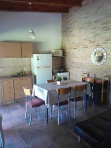 a kitchen with a table and chairs in a room at Casa Las Tardes, Roldan in San Lorenzo +1 photo